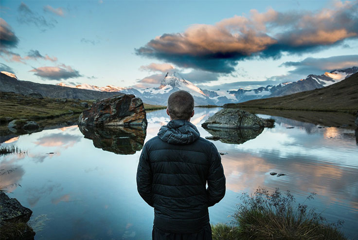 Man looking out at peaceful nature scene