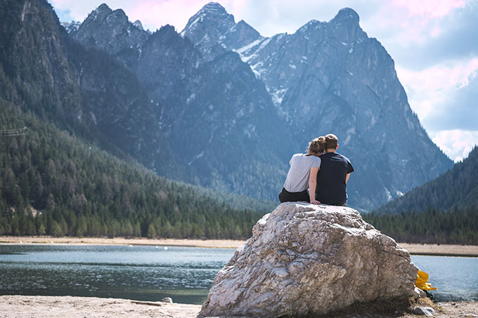 Couple sitting on a rock in nature